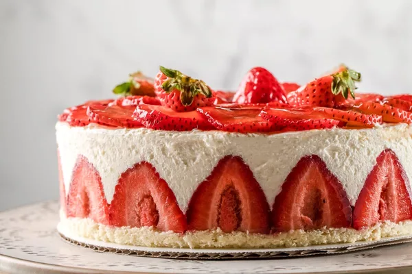 Strawberry fraisier cake, cut to show the layers